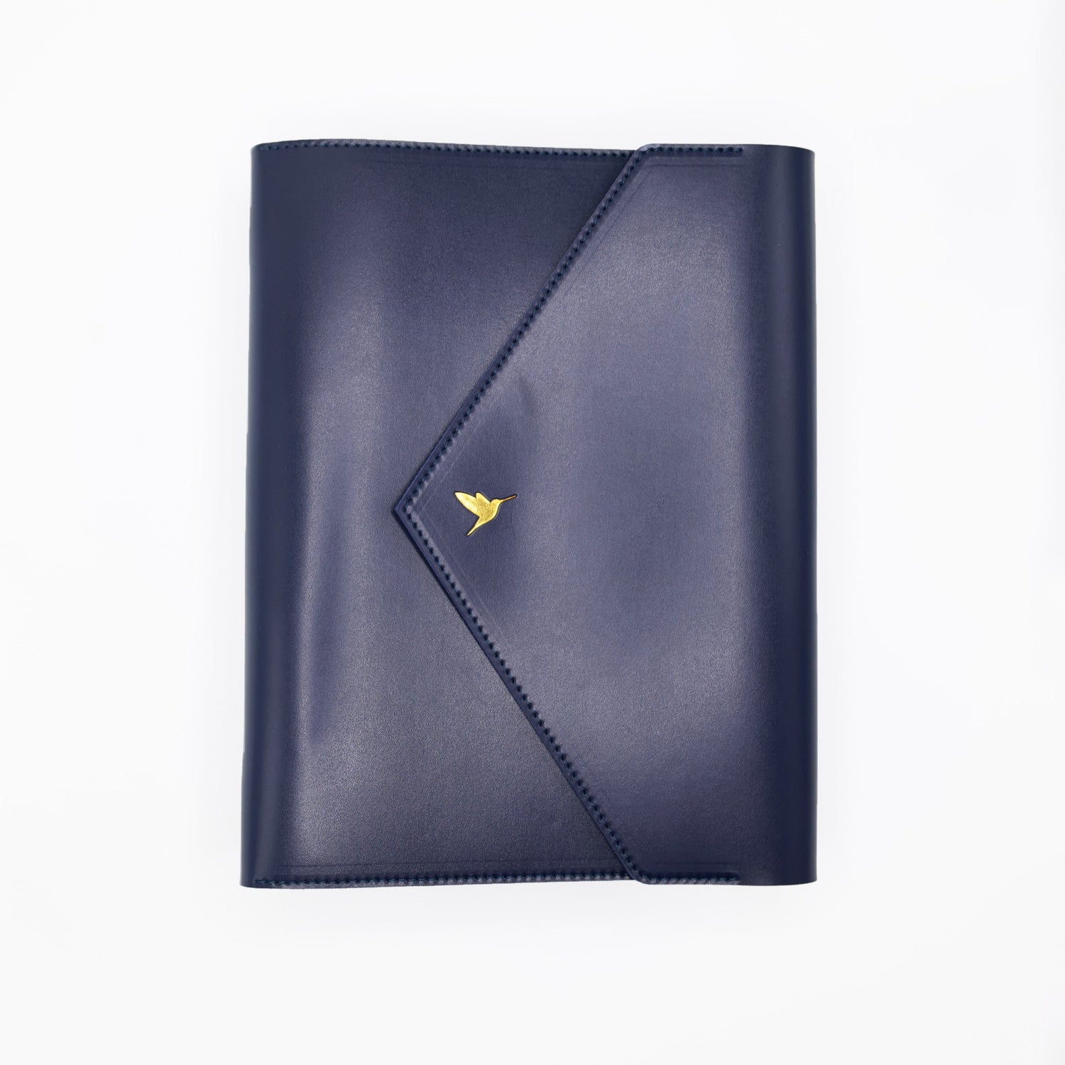 The Hummingbird Planner in navy vegan leather, featuring a gold foil hummingbird stamp. This customisable A5 planner is shown closed from the front, highlighting the premium personalised planner cover and elegant gold hardware.