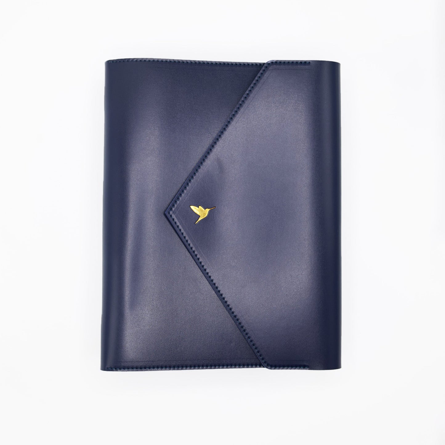 The Hummingbird Planner in navy vegan leather, featuring a gold foil hummingbird stamp. This customisable A5 planner is shown closed from the front, highlighting the premium personalised planner cover and elegant gold hardware.