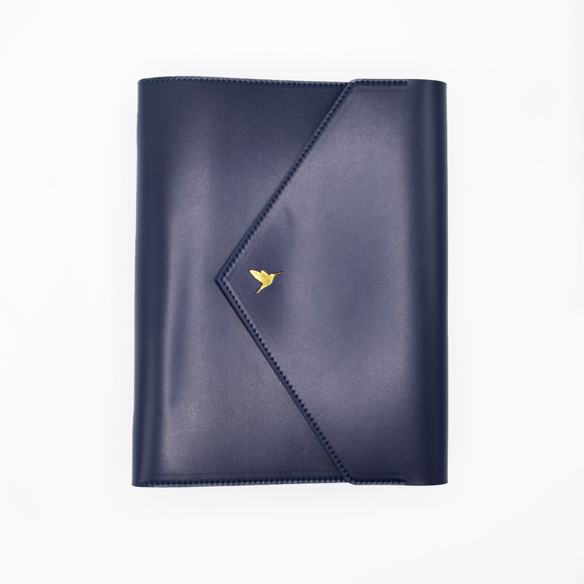 The Hummingbird Planner in navy vegan leather, featuring a gold foil hummingbird stamp. This customisable A5 planner is shown closed from the front, highlighting the premium personalised planner cover and elegant gold hardware.