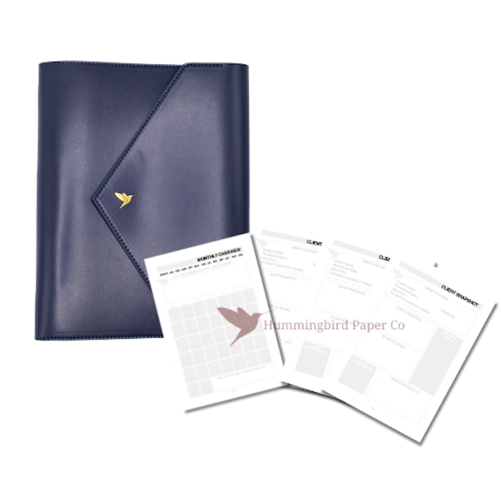 The Strategist Bundle featuring The Hummingbird Planner closed in navy vegan leather with gold foil stamp, shown with one monthly planner insert and three client planner inserts. This personalised A5 planner system is designed for service providers, creatives, and professionals managing multiple clients and projects.